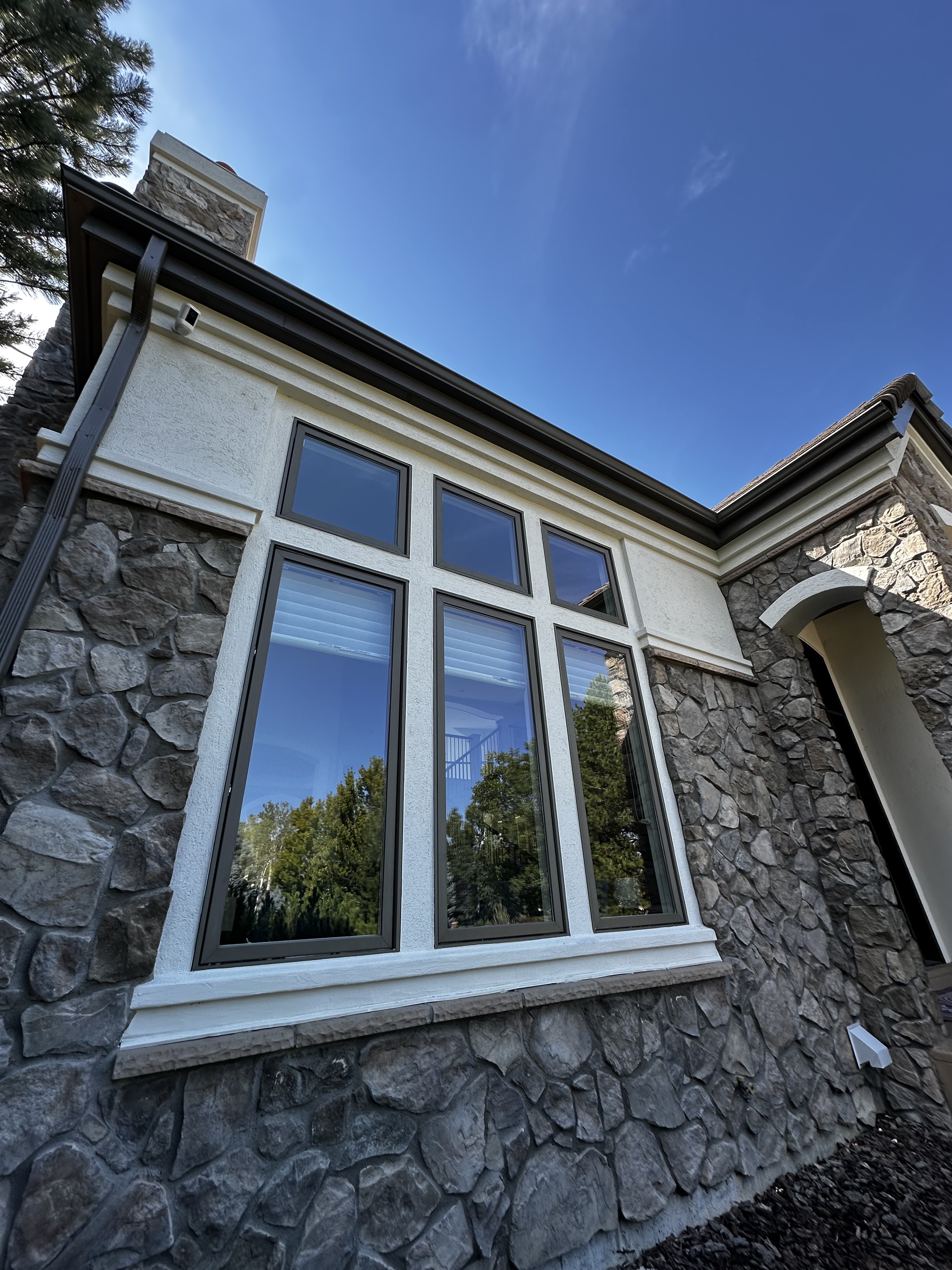 Tall exterior windows framed by a stone facade