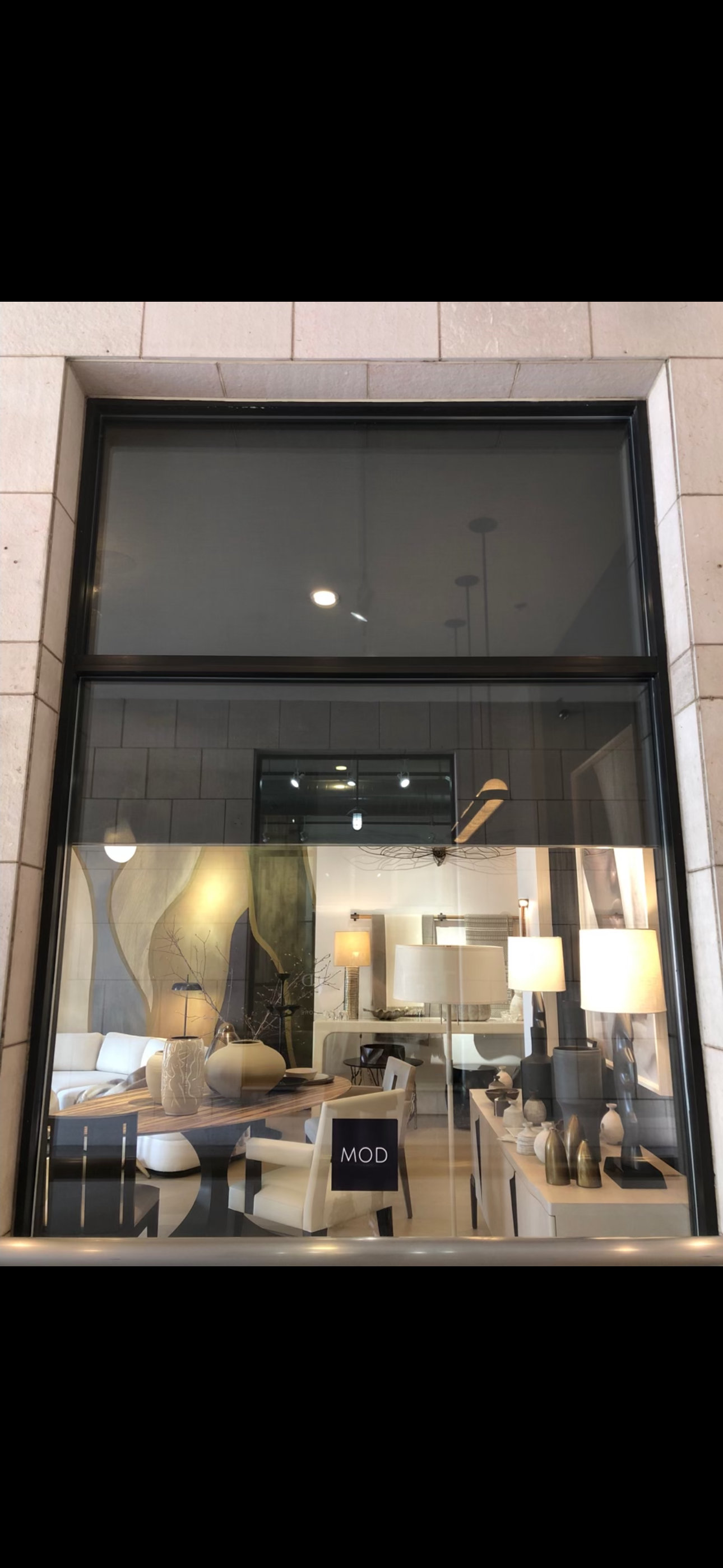 Technician cleaning high commercial windows